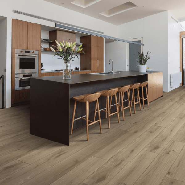A kitchen with wooden floors and a bar.
