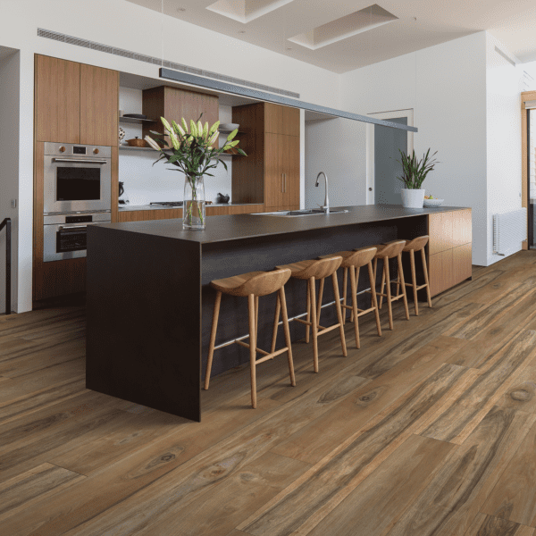 A kitchen with wooden floors and a bar.