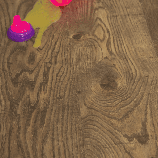 A wooden floor with some pink and yellow objects on it