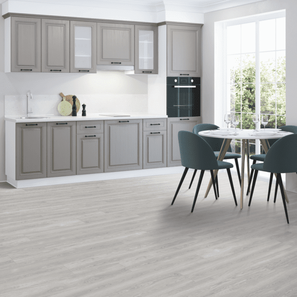 A kitchen with grey cabinets and white counters.