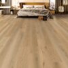 A bedroom with a bed and a large wooden floor