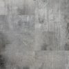 A gray concrete wall with some black spots on it