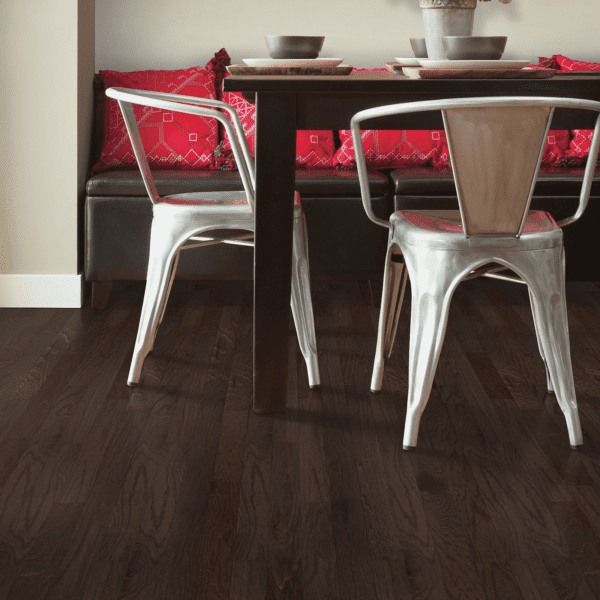 A dining room with two chairs and a table.