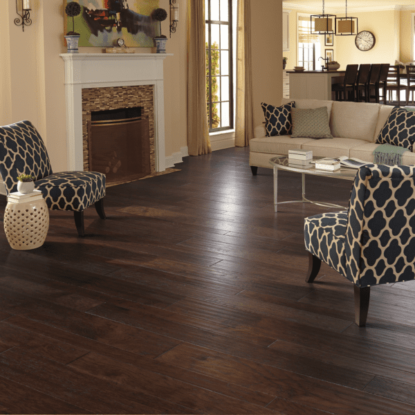 A living room with hardwood floors and furniture.