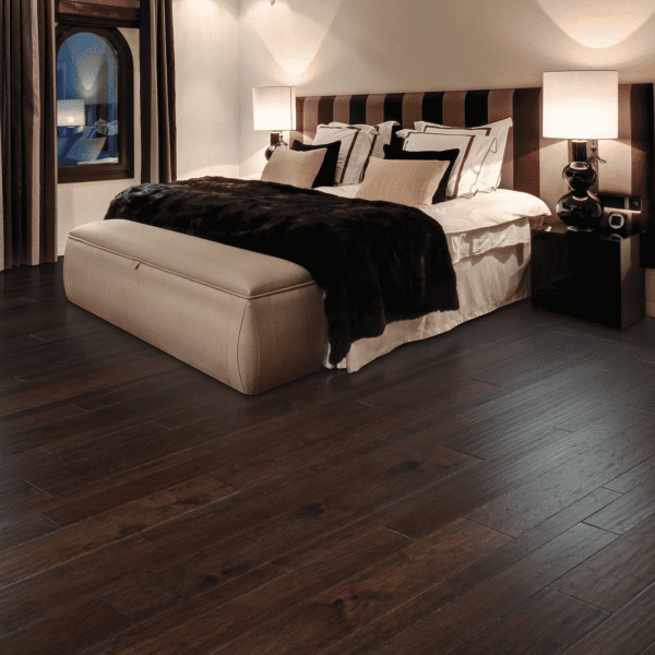 A bedroom with a bed and two night stands.
