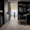 A walk in closet with black cabinets and a view of the ocean.