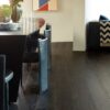 A dining room table and chairs in front of a couch.