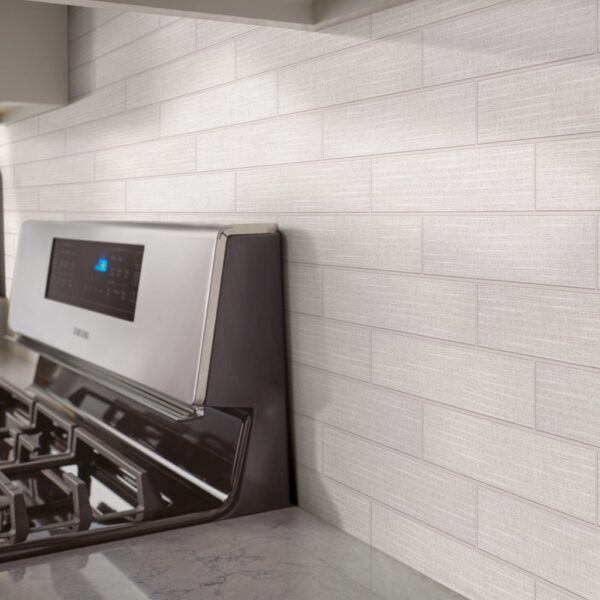 A stove with the oven on in front of it.