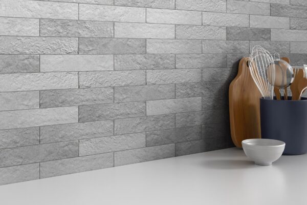 A white counter top with a bowl and cutting board on it.