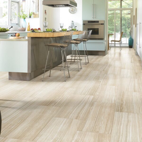 A kitchen with white walls and wooden floors.