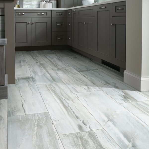 A kitchen with grey cabinets and white floor