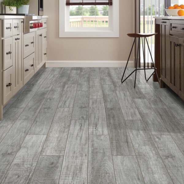 A kitchen with wooden floors and white cabinets.