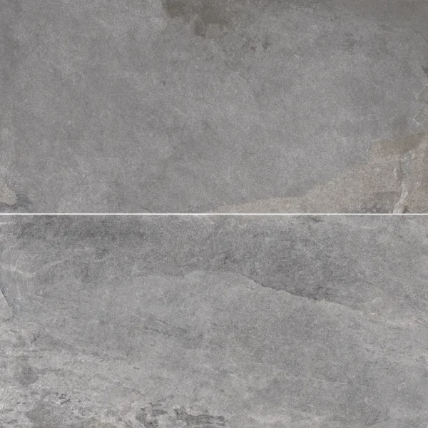A gray stone wall with some white spots on it