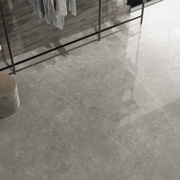 A view of a floor with a mirror in the background.