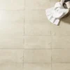 A person is holding onto some towels while standing on the floor.
