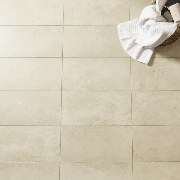 A person is holding onto some towels while standing on the floor.