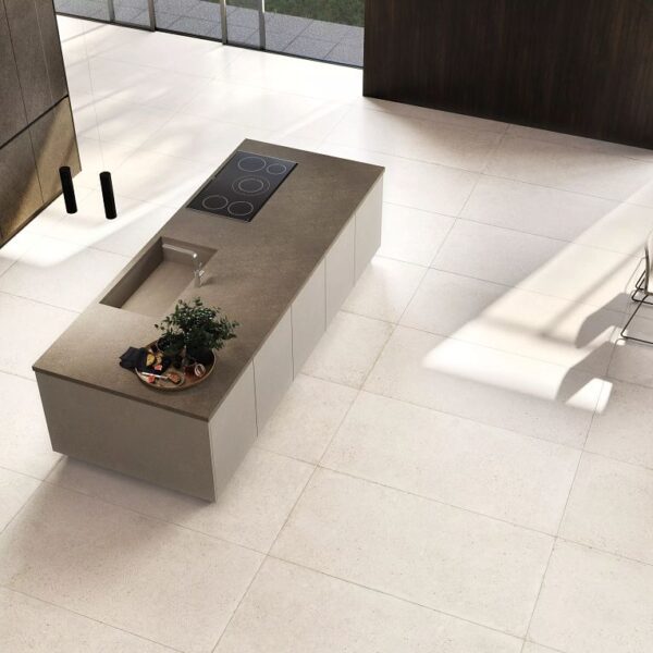 A white tile floor with a plant in the middle of it.