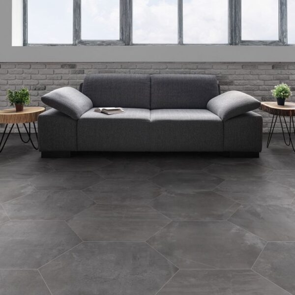 A couch and two tables in front of a window.