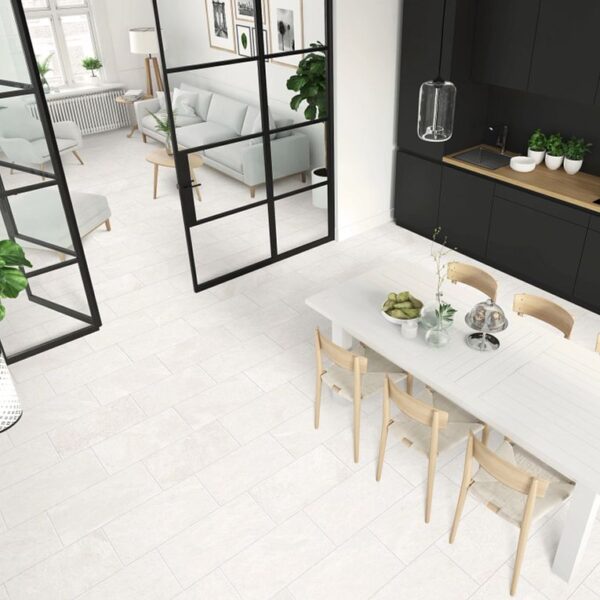 A dining room with white chairs and table