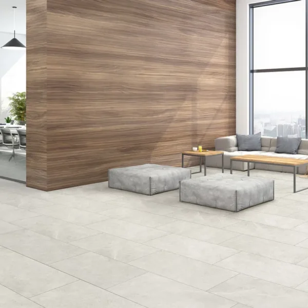 A room with two tables and chairs, a couch and a wall.
