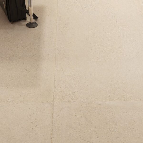 A white tile floor with some black and white tiles