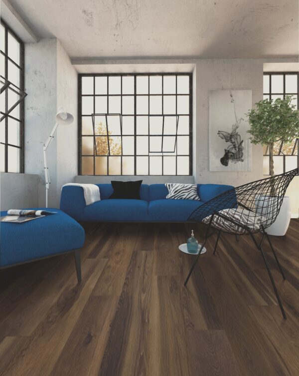 A living room with blue furniture and large windows.