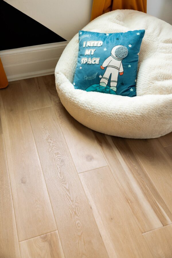 A dog bed and pillow on the floor.