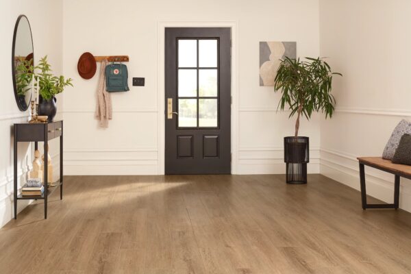 A door in the middle of a room with wood floors.