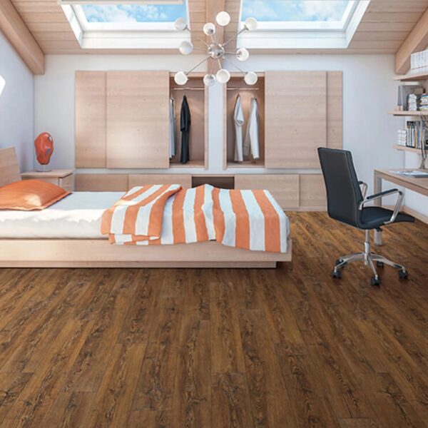 A bedroom with a bed, desk and chair.