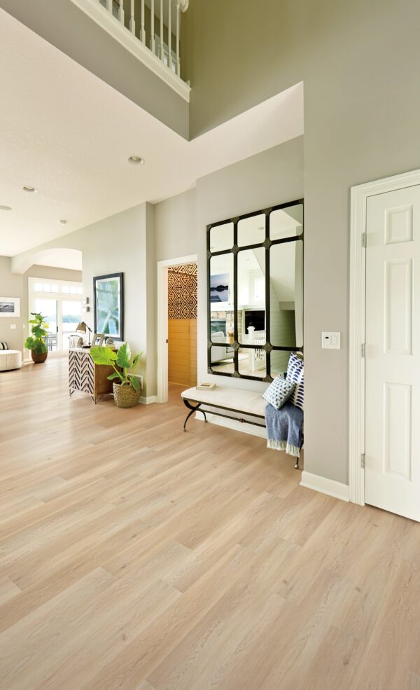 A room with hard wood floors and a large mirror.