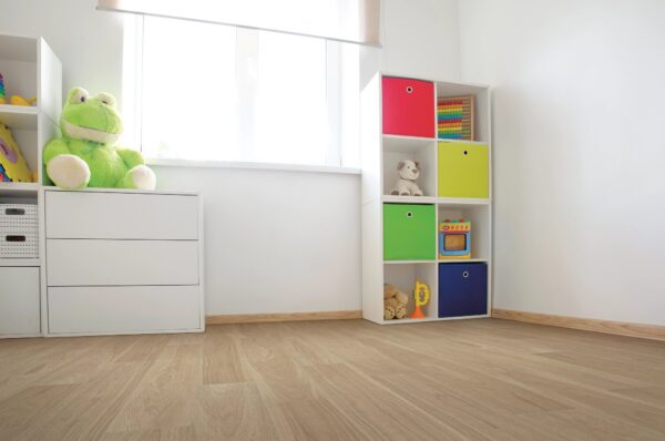 A room with a white wall and wooden floors