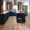 A kitchen with blue cabinets and wooden floors.