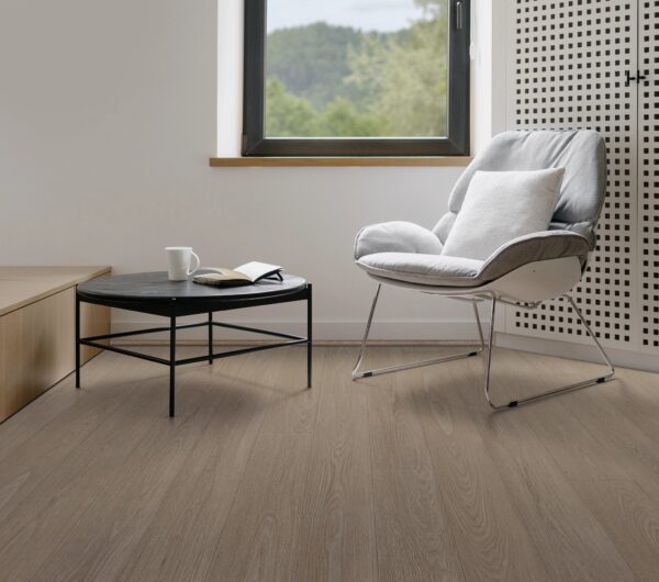 A chair and table in front of a window.
