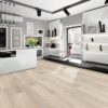 A room with white walls and floors, and a black counter.