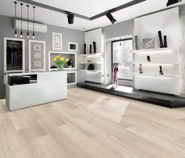 A room with white walls and floors, and a black counter.