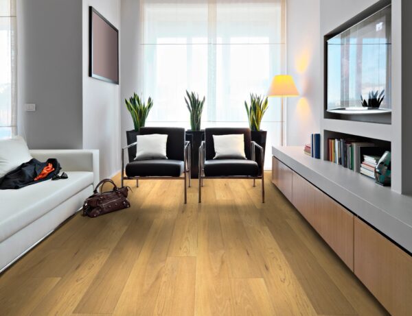 A living room with two black chairs and a television.
