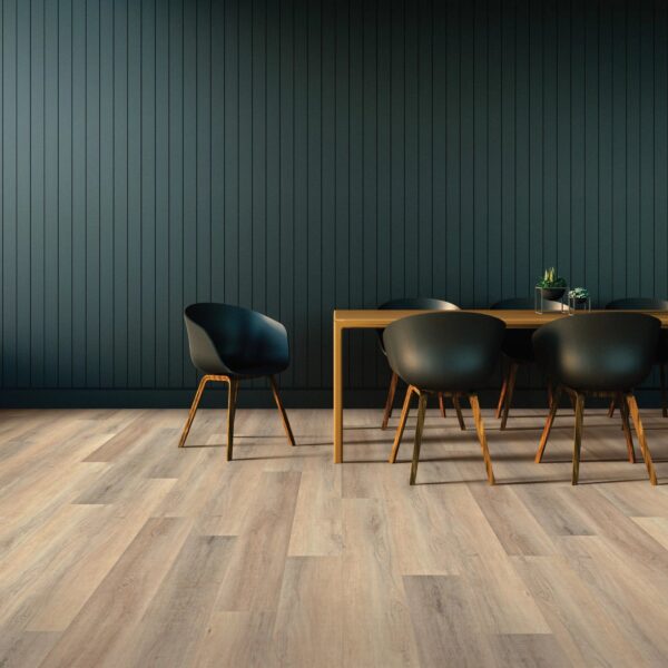 A table and chairs in front of a wall.