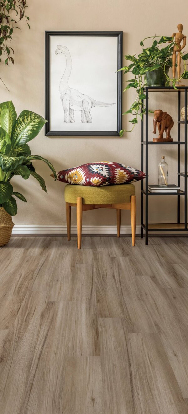 A chair and table in a room with plants.