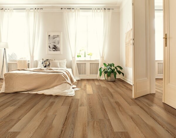 A bedroom with wood floors and white walls.