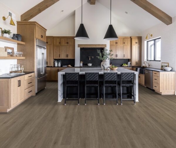 A kitchen with black chairs and a large island.