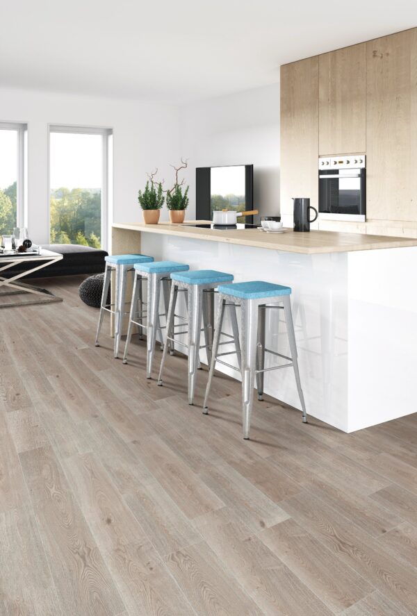 A kitchen with wooden floors and blue stools.