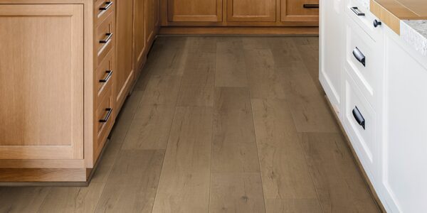 A kitchen with wooden cabinets and floor.