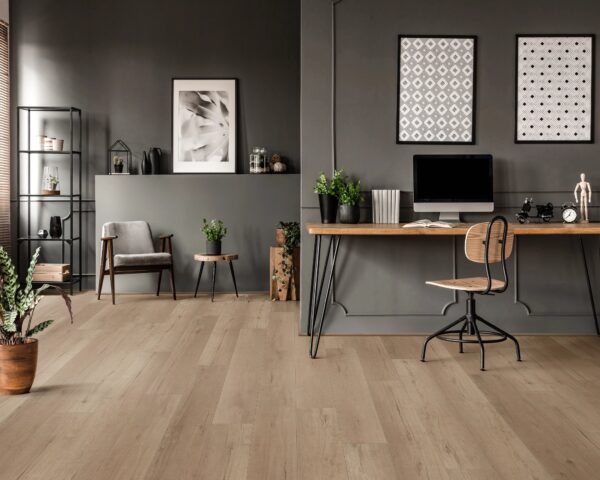 A room with a desk and chair, computer on the wall.
