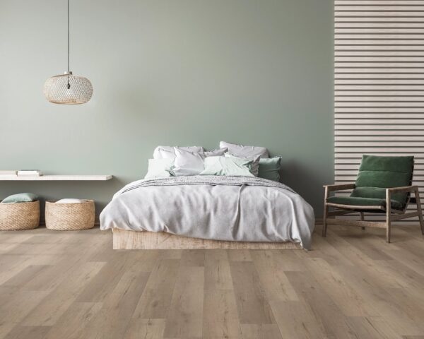 A bedroom with a bed and chair in it