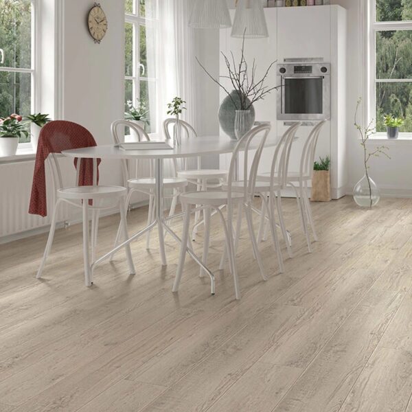 A dining room with white chairs and table