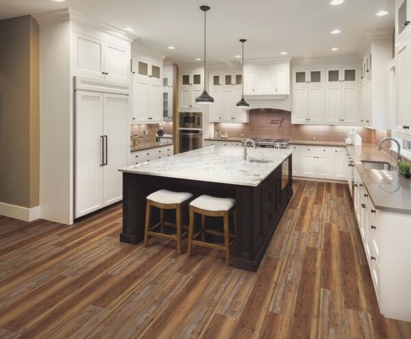 A kitchen with white cabinets and wooden floors