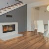 A room with a fireplace and wooden floors