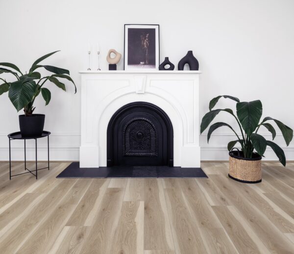 A fireplace with a white mantle and black trim.
