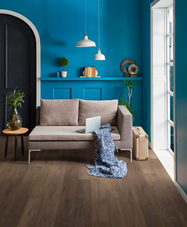 A living room with blue walls and brown furniture.