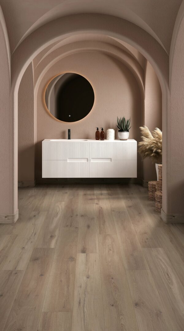 A white sink sitting under a mirror in the middle of a room.